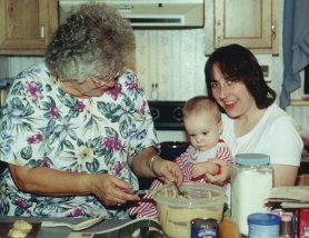 Grandma teaching Ashley how to bake Christmas cookies.